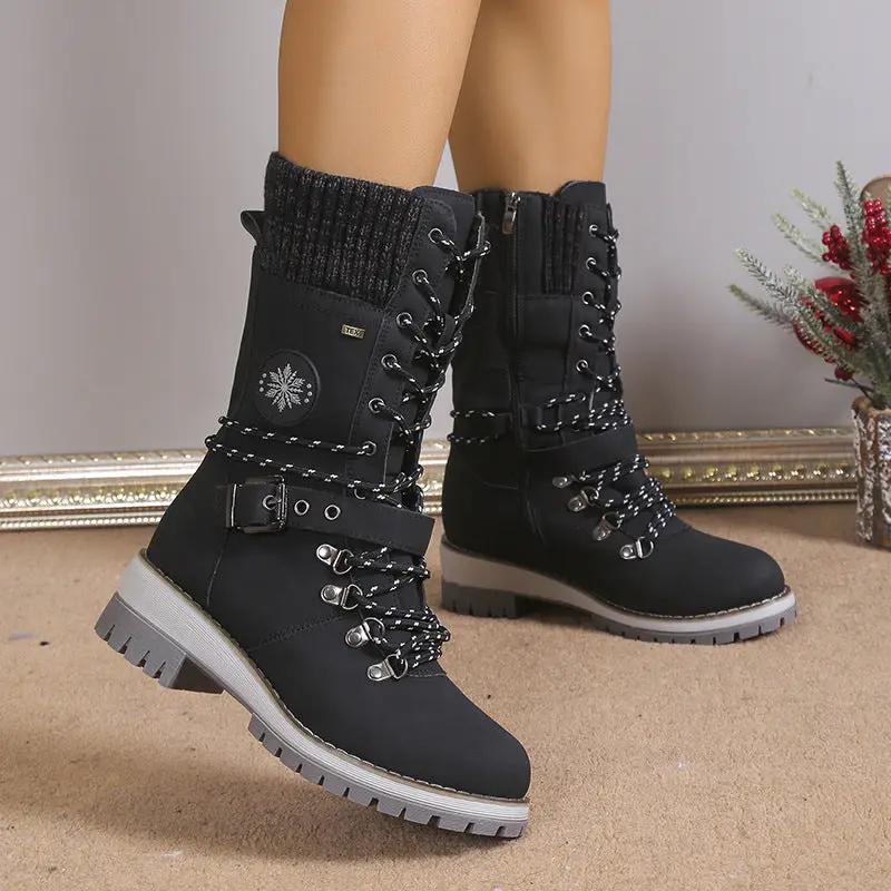 Pair of AdTec fur-integrated black knee-high snow boots with thick laces and chunky gray lug soles