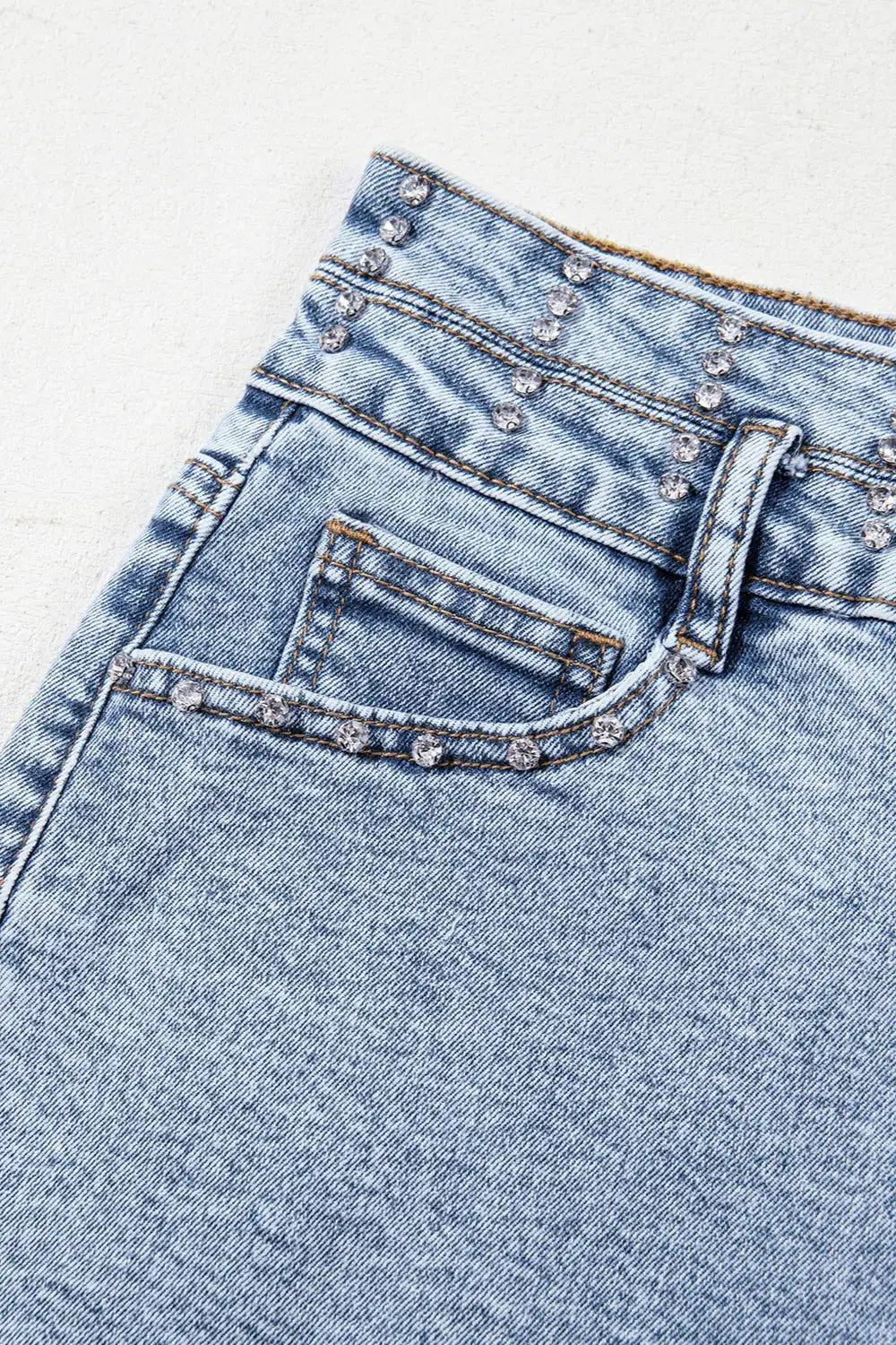 Women’s high-waist rhinestone light-wash denim shorts with a raw hem by Trendsi