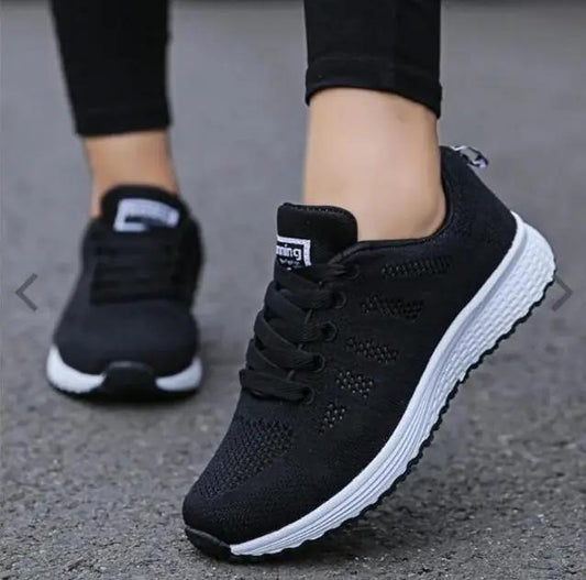 Women's sports sneakers by AdTec in black with knit upper and white sole, lace-up athletic shoes.
