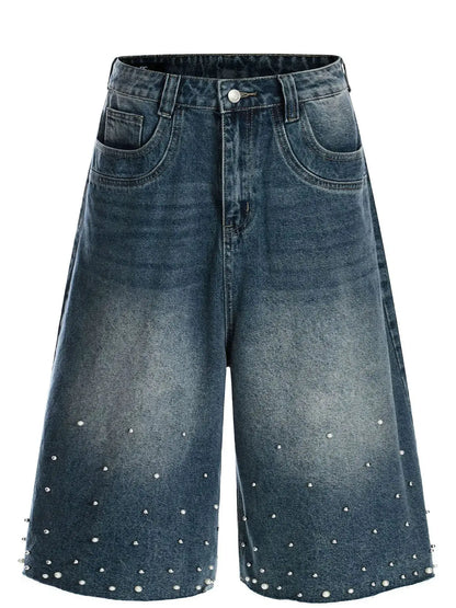 Men's relaxed wide-leg denim shorts in blue washed denim with pearl studs along the hem