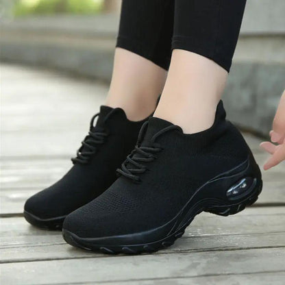 Women's black knit sneakers with lace-up front and air-cushioned chunky sole