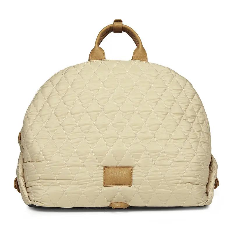 Pet handbag in beige quilted fabric with tan leather handles and trim