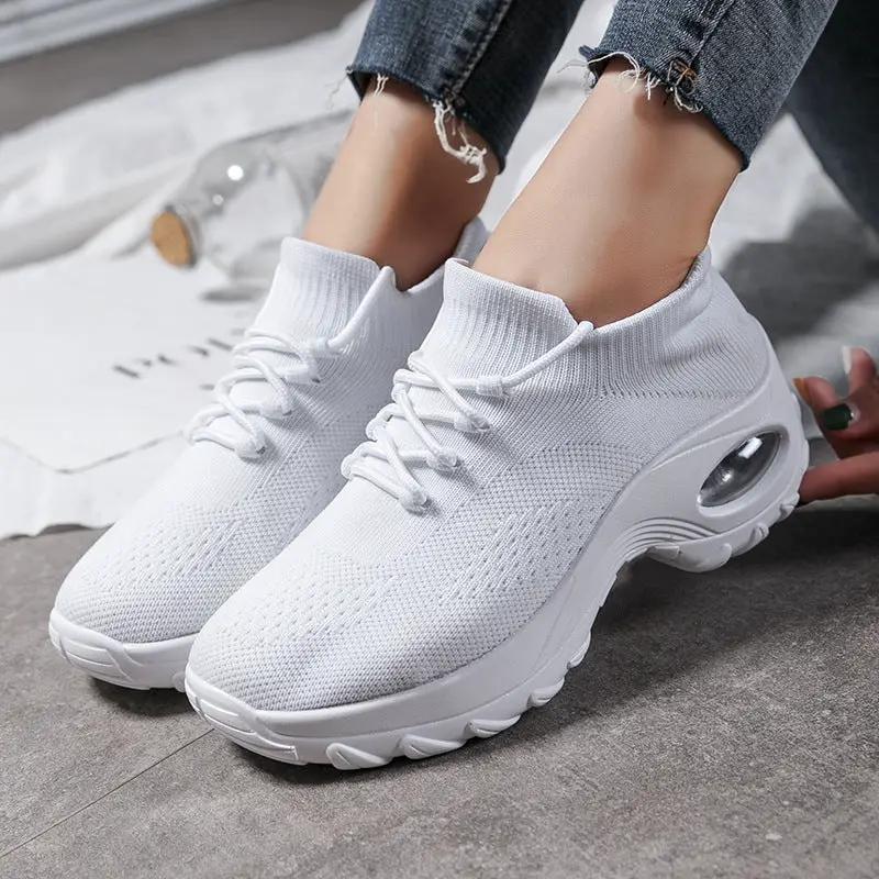 White knitted women's athletic sneakers with sock-like collar and visible air-cushion sole