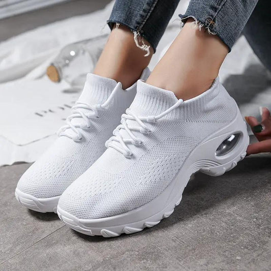 White knitted women's athletic sneakers with sock-like collar and visible air-cushion sole