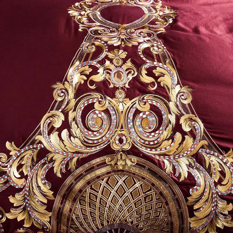 Embroidered cotton quilt cover by AdTec in burgundy with gold ornate pattern