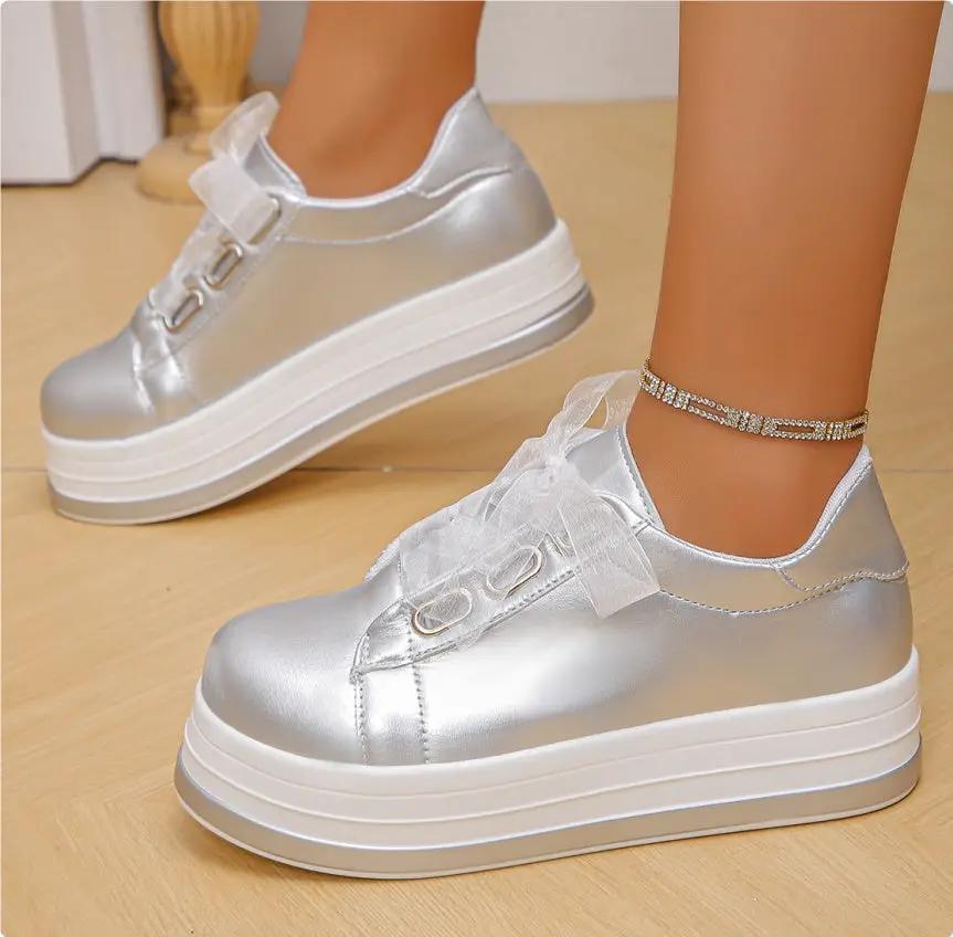 Pair of AdTec women's silver metallic platform lace-up flats with round toe, white sole
