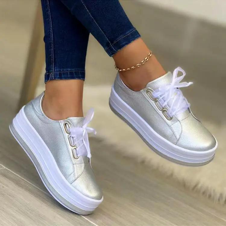 Platform lace-up sneakers with silver metallic upper, round toe, white chunky sole