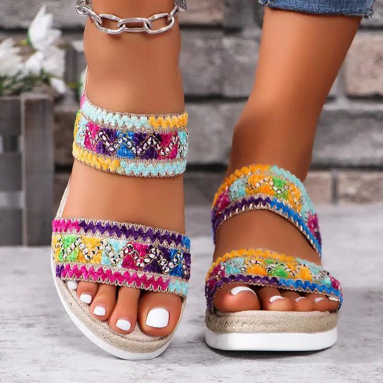 Pair of women's fashion wavy-pattern woven sandals with multicolor straps and linen-bottom wedges