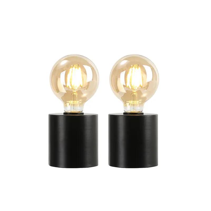 7-inch tall black battery-powered table lamps (set of 2) with clear glass Edison bulbs and black cylindrical bases.