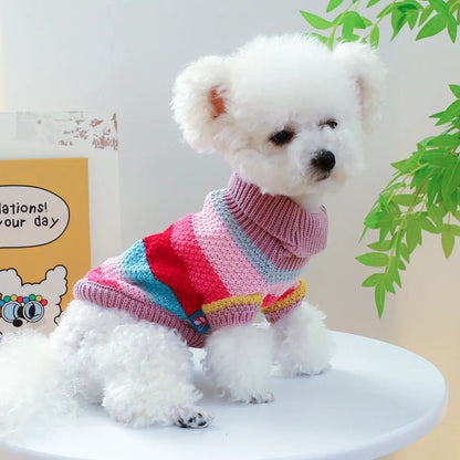 Pet sweater: colorful striped knit with a turtleneck worn by fluffy white dog, AdTec brand.