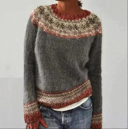 Round-neck multicolor knit pullover sweater with grey body and red-cream Fair Isle pattern at the yoke and cuffs.