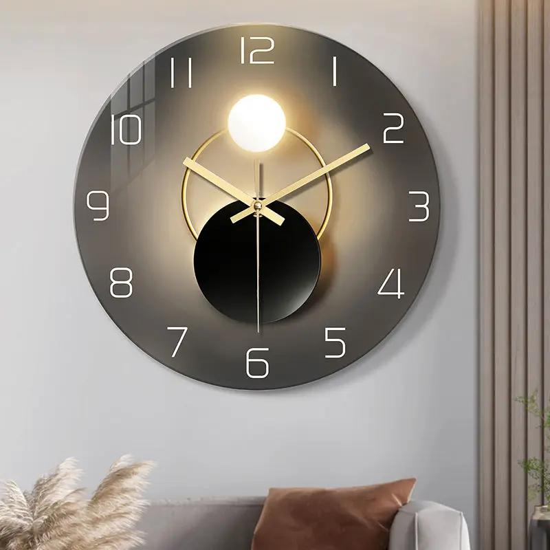 Wall-mounted decorative clock by AdTec, round grey metal with gold accents and visible numerals.
