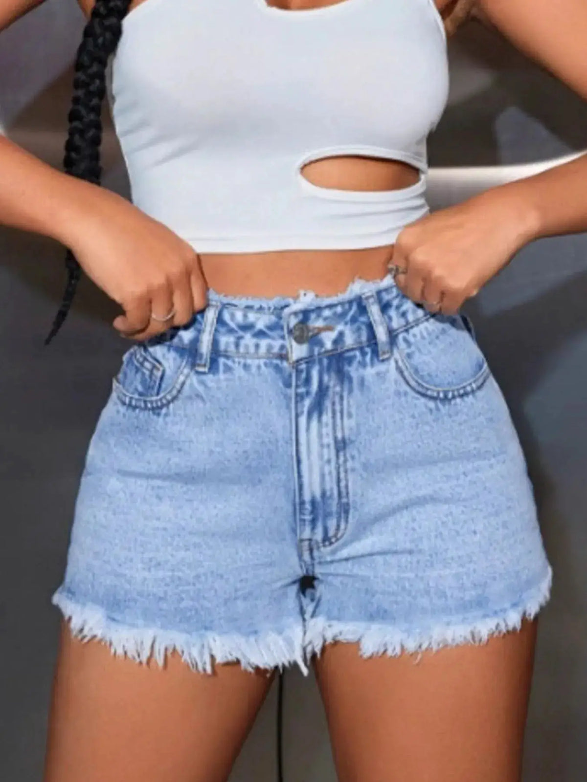 High-waisted light-blue denim shorts with a frayed hem and stretch fabric