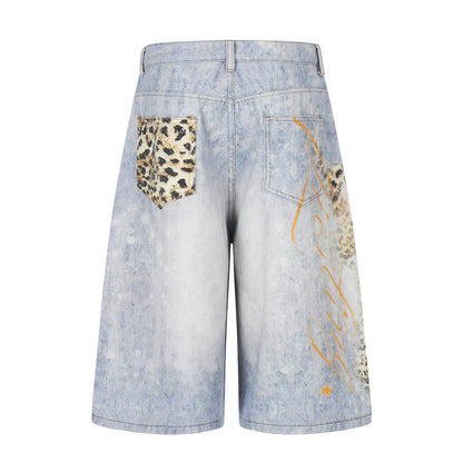 Leopard-print denim cropped pants with patch pockets and graffiti accents in light wash blue