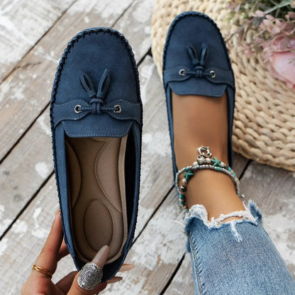 Women's navy blue round-head loafers with tassel detail and non-slip cushioned insole.