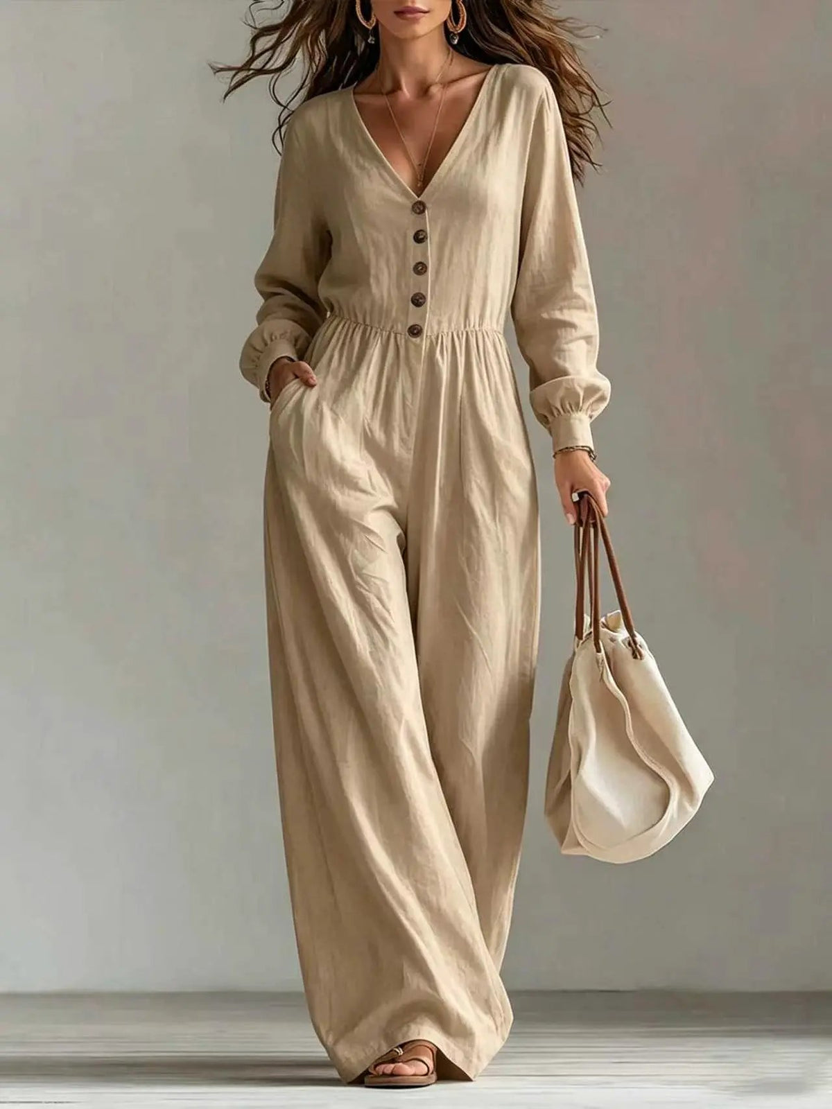 Womens beige V-neck long-sleeve jumpsuit with pockets and button placket, wide-leg.