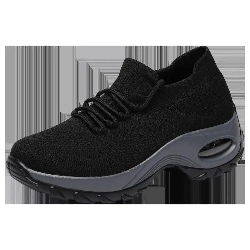 Women’s black knit athletic sneaker with gray midsole and chunky outsole.