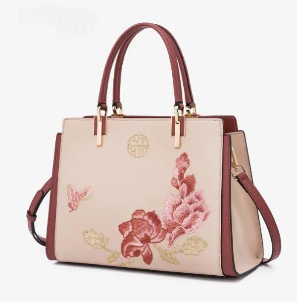 AdTec handbag tote with floral embroidery, beige-pink body, burgundy trim and gold hardware