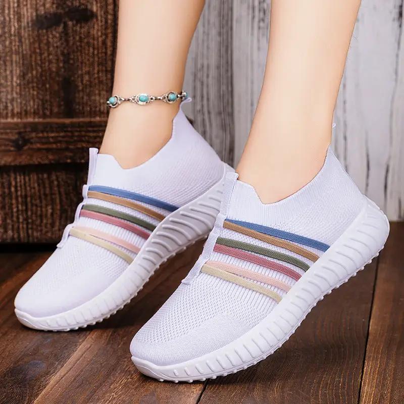Women's breathable mesh casual slip-on shoes with white knit upper, pastel stripe bands, white sole.