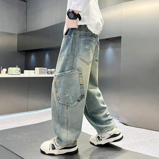 Boy's casual denim jeans in light blue, loose straight-leg fit with large side patch pocket