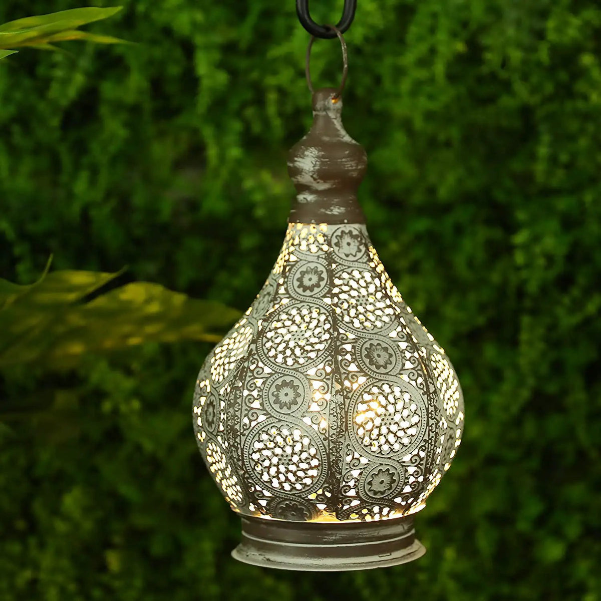 11.5-inch tall battery-powered table lamp with ornate metal lattice shade and warm glow