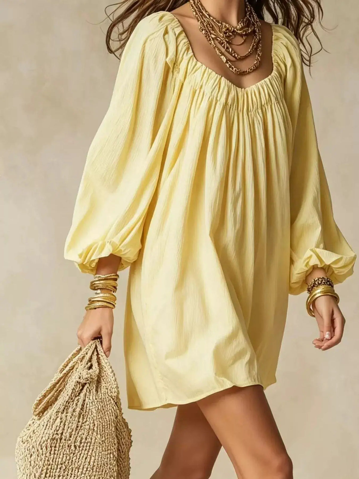 Flowy balloon-sleeve mini dress in pale yellow with a gathered neckline.