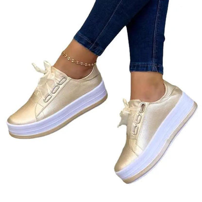 AdTec women's metallic gold platform lace-up sneakers with round toe and thick white sole, pair