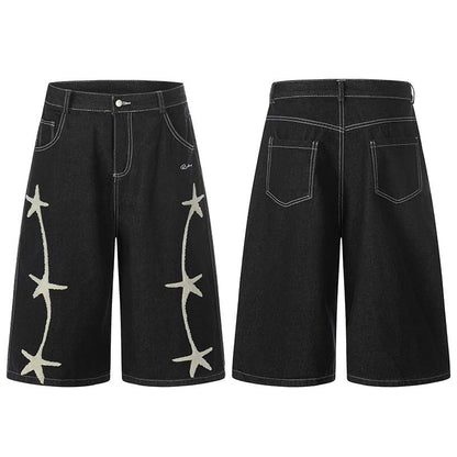 Black washed denim cropped shorts with white star embroidery along the sides
