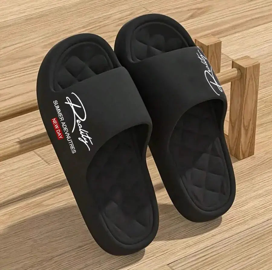 Pair of black EVA men's slide slippers with quilted footbeds and wide straps for indoor or outdoor use