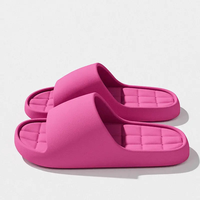 Pair of pink unisex slides with cushioned grid insole