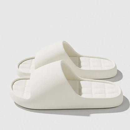 White unisex slide sandals with cushioned grid footbed and non-slip sole