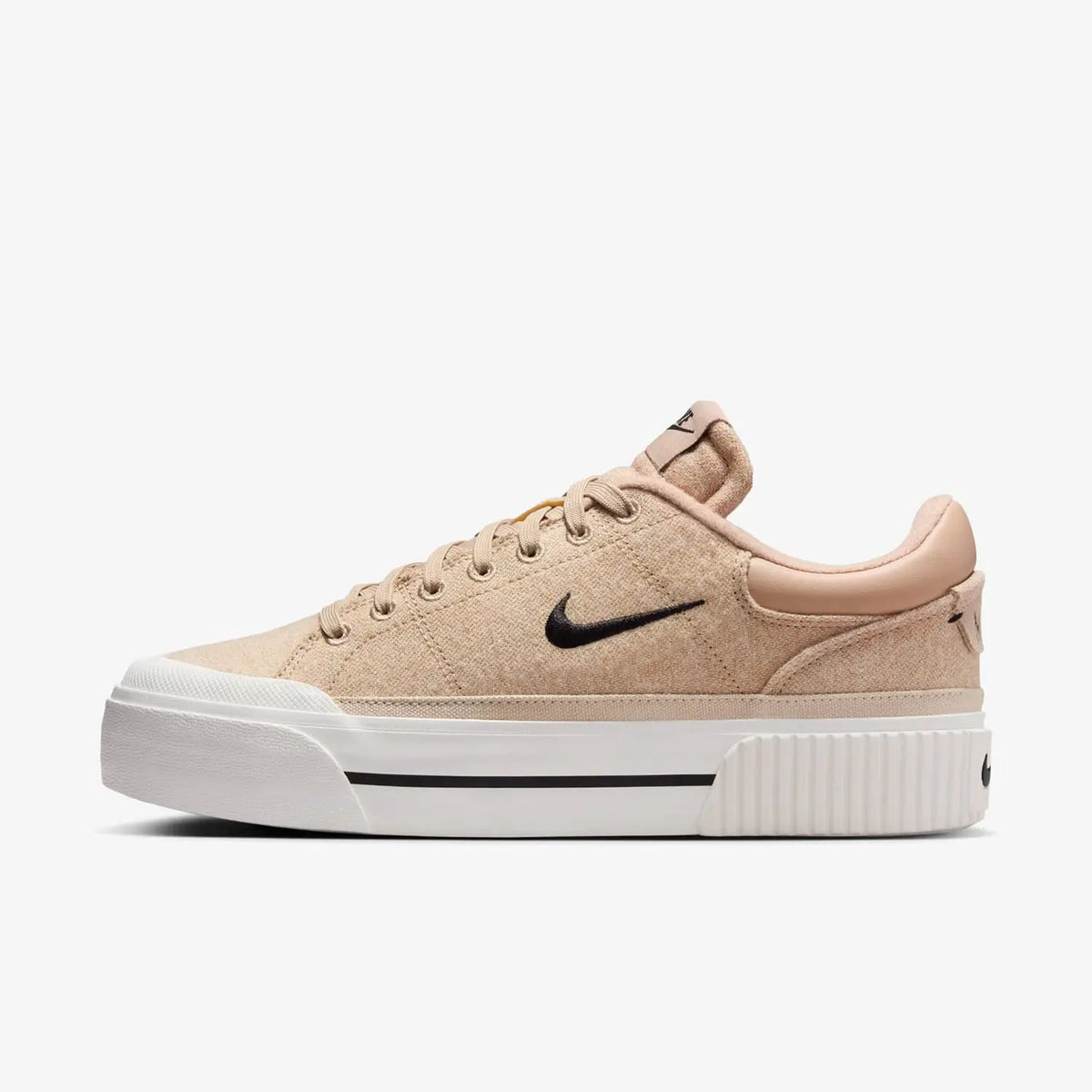 Nike Court Legacy Lift women's sneakers, beige textured fabric upper with black swoosh and white platform sole.