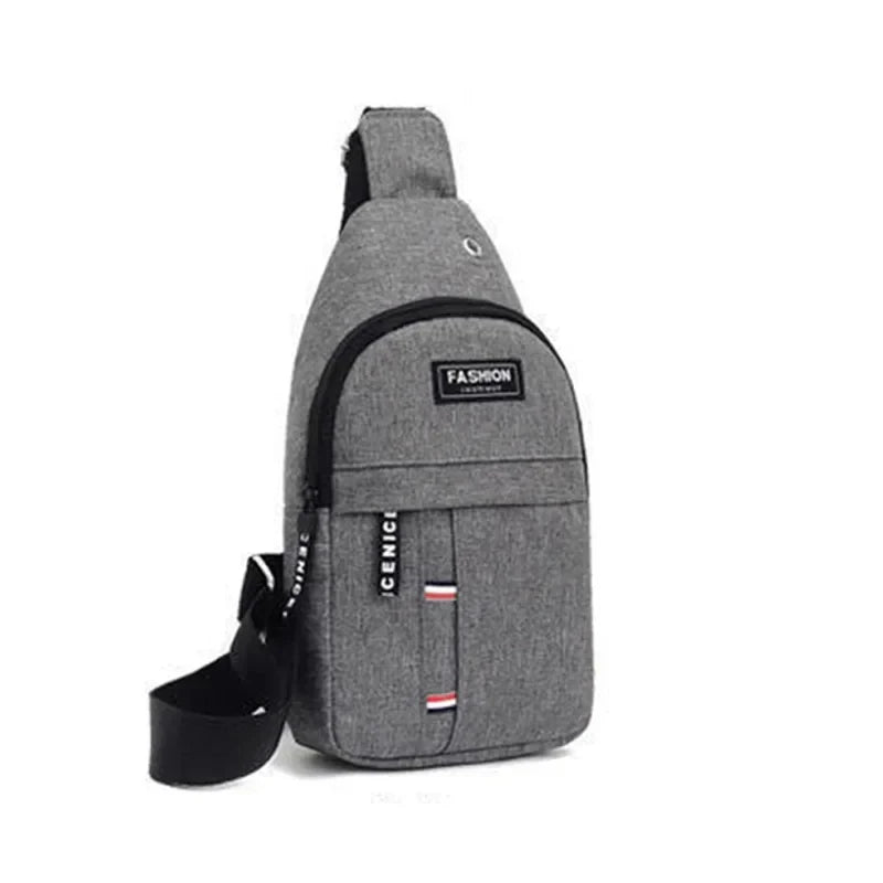 Men's grey crossbody sling bag with adjustable strap, front zipper pocket, striped accents, and a fashion label patch