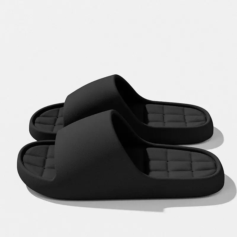 Black unisex slide sandals with solid wide strap and cushioned textured footbed