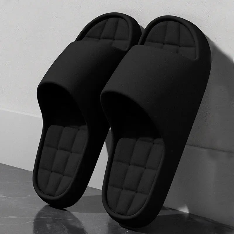Unisex black slide sandals with quilted footbeds, lightweight and non-slip.