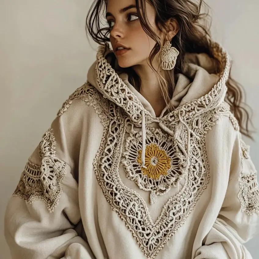 Hooded women's beige hoodie with intricate crochet lace trim and yellow floral embroidery on the chest.