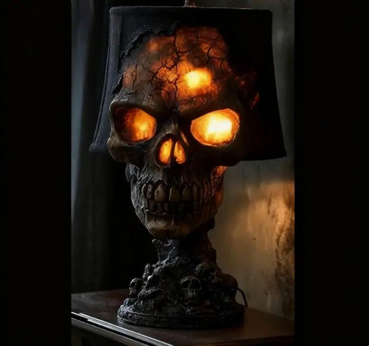 Halloween lava stone skull desk lamp with glowing orange LED eyes on a mantel.