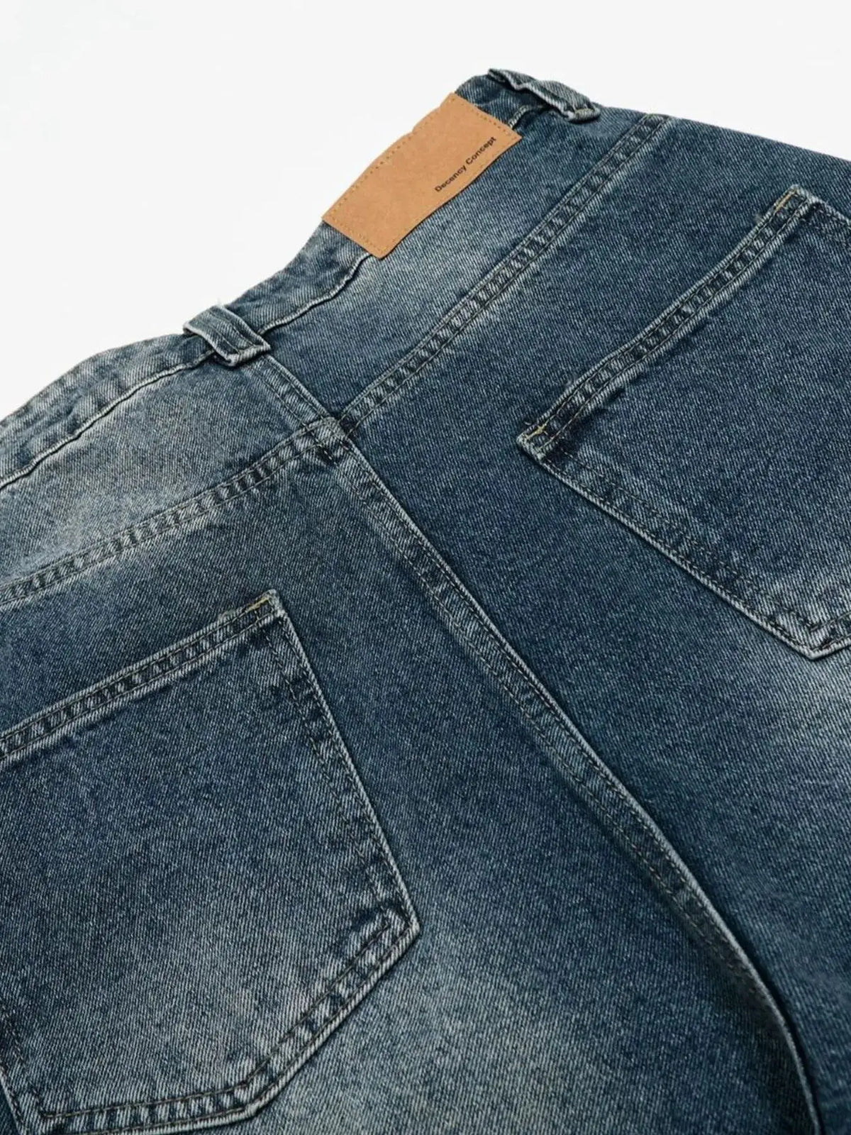 Men's relaxed wide-leg denim shorts with back pockets and tan leather patch