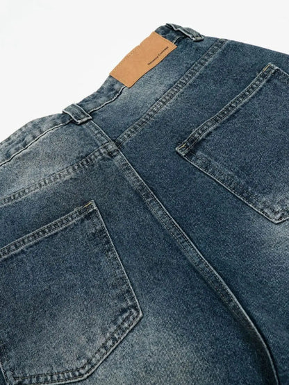 Men's relaxed wide-leg denim shorts with back pockets and tan leather patch