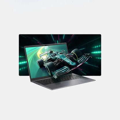 Laptop with metallic gray body displaying a vivid racing car graphic on its screen