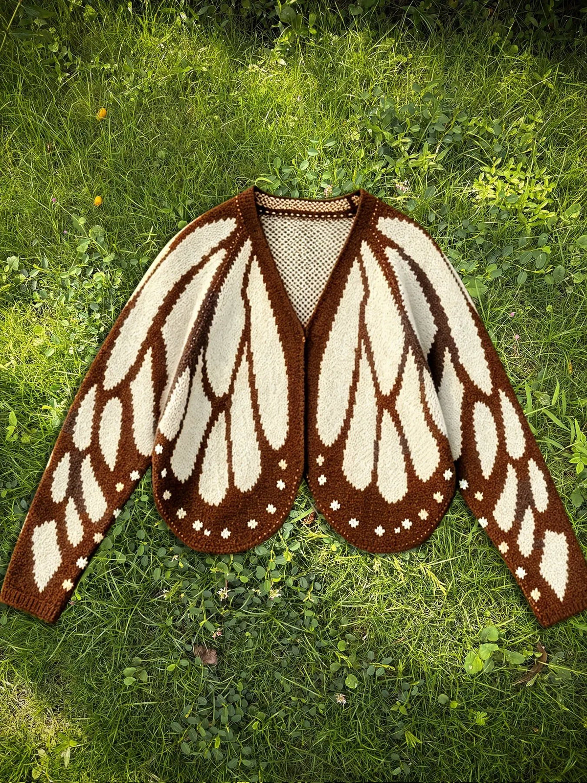 Women's butterfly knit cardigan sweater in brown and cream, open-front with long sleeves.