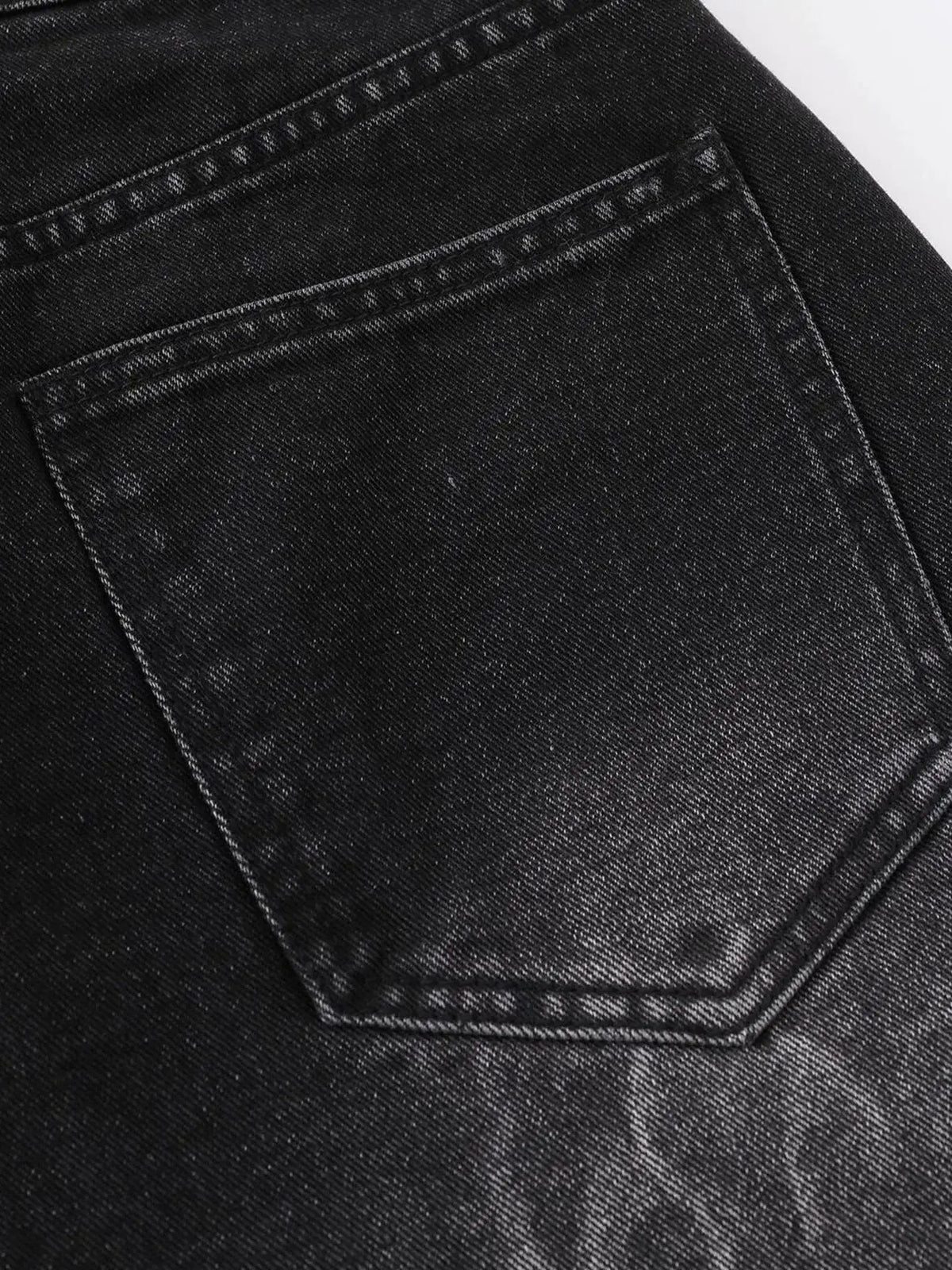 Men's dark denim shorts back pocket close-up with contrast stitching