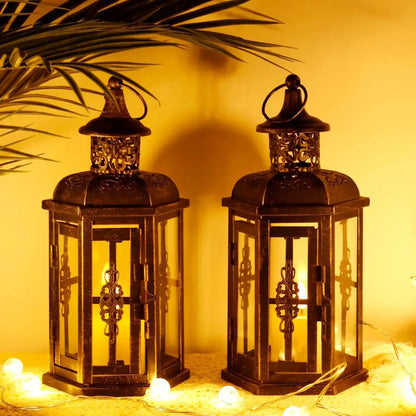 10-inch decorative candle lanterns in antique bronze metal with glass panels; set of 2