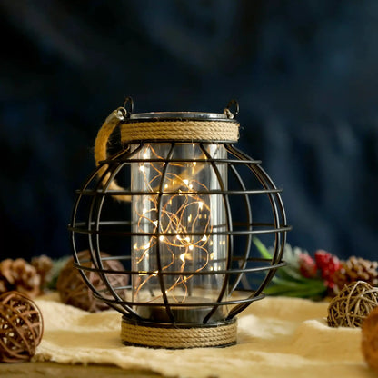 7.3in tall battery-powered table lamp with a hemp rope cage and warm fairy lights inside a metal frame lantern