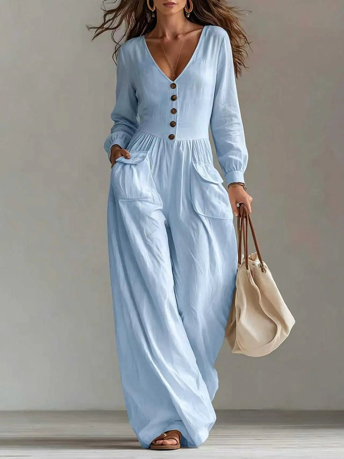 Light blue women's v-neck long-sleeve jumpsuit with wide legs, front buttons and pockets