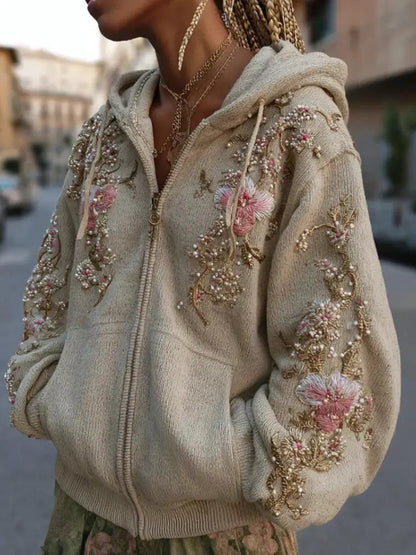 Hooded beige women's hoodie with pink floral embroidery and bead embellishments.