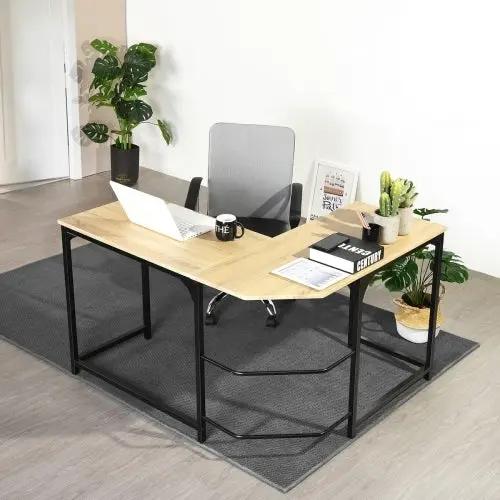 L-shaped wooden desk with black metal frame in an office setup; laptop, mug, and books on top.