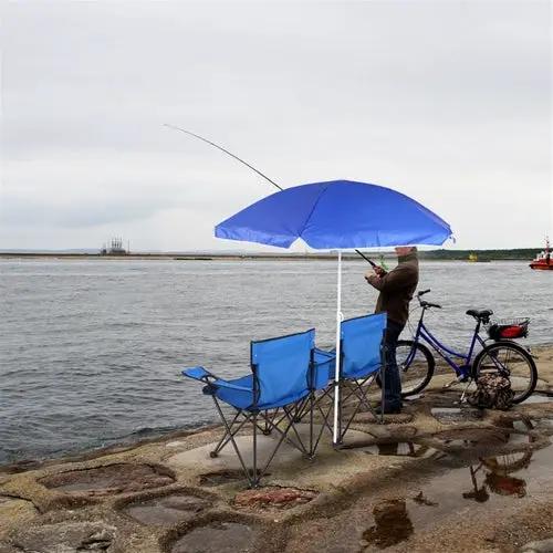 Portable outdoor 2-seat folding chair with removable sun umbrella, two blue chairs by water with a person fishing.