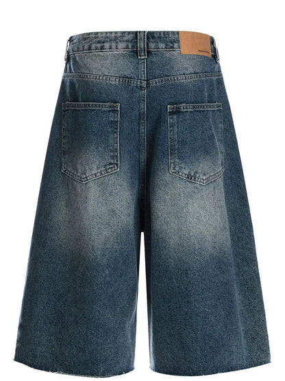 Men's relaxed wide-leg denim shorts in blue washed cotton, back view with large pockets and leather label by Trendsi