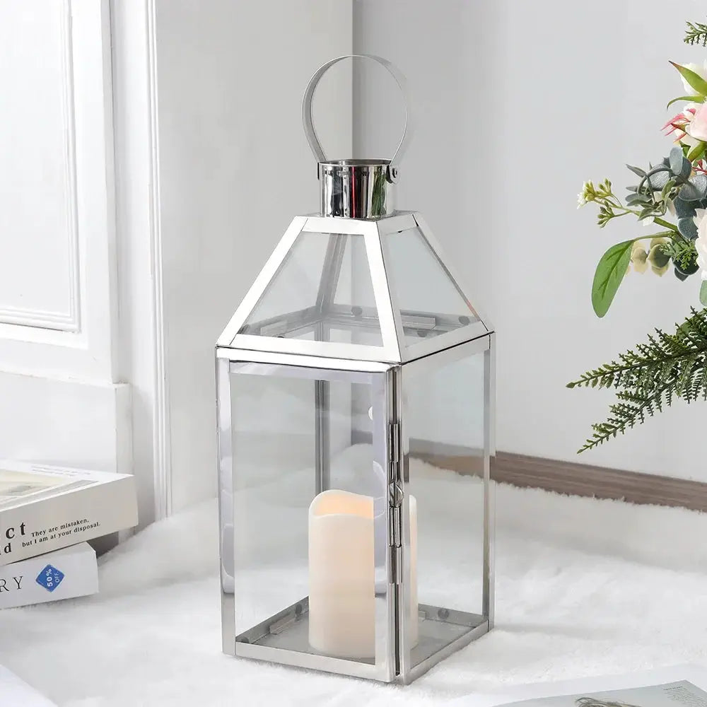 16-inch high decorative lantern with glass panels and chrome metal frame, candle inside